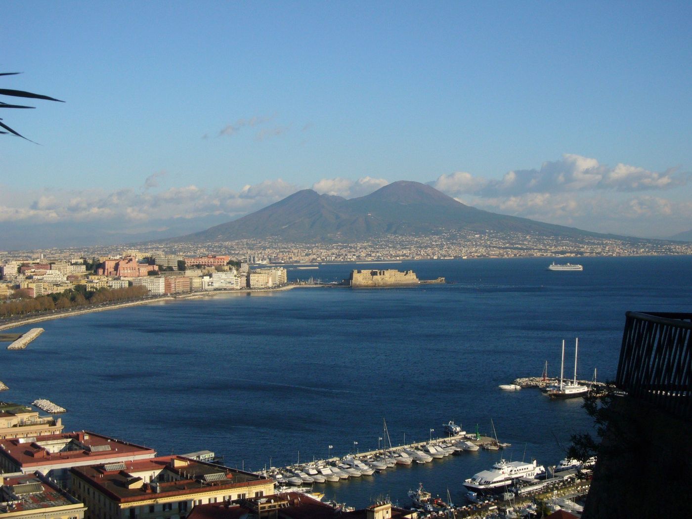 The Bay of Naples with Mount Vesuvius behind the city and boats in the harbour