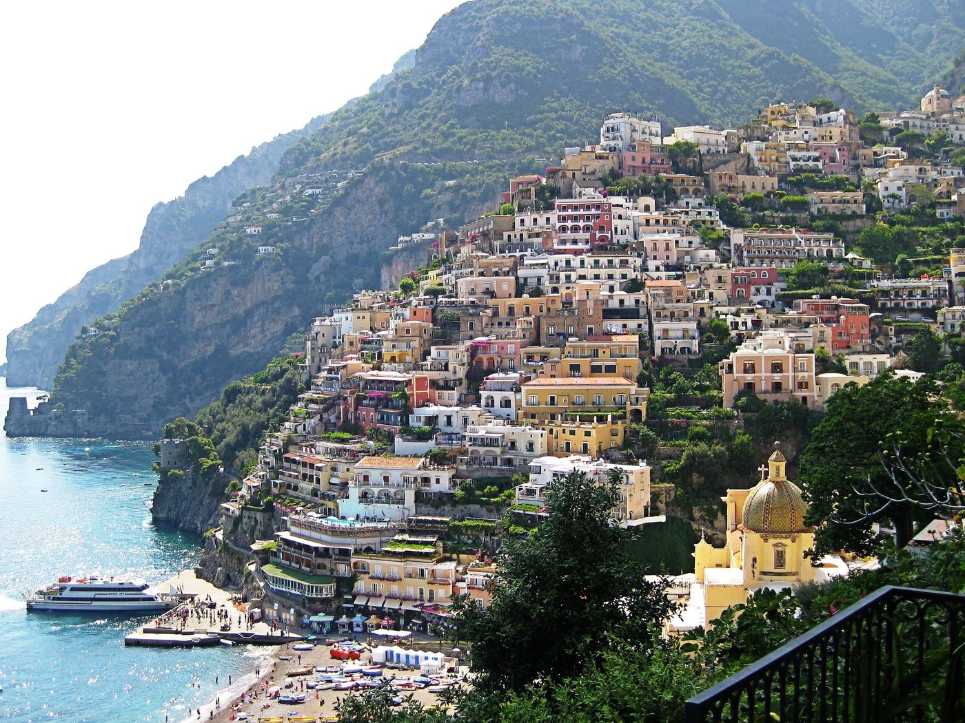 Positano climbing the cliffside above the sea, with its tiled church dome below