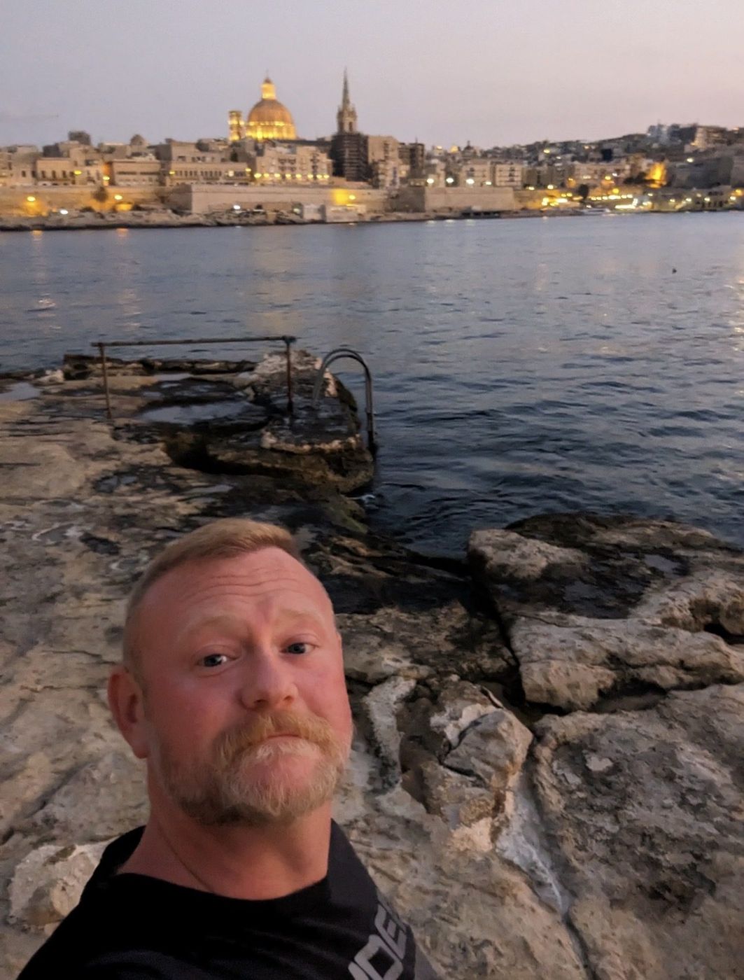 Derrick Fields, founder of Ursus Travel, on the waterfront at dusk