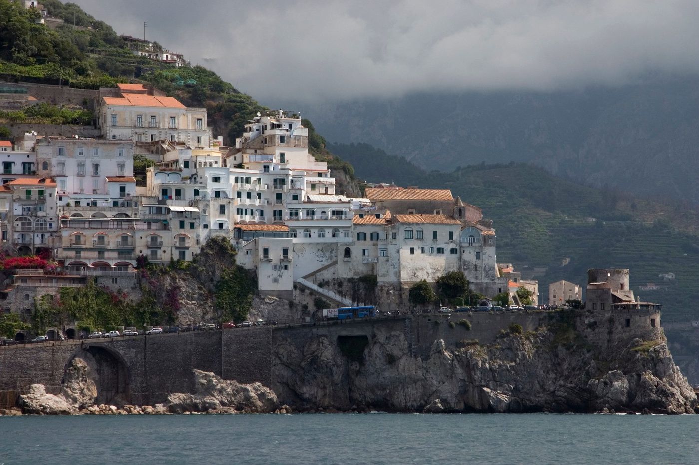 A white town stacked on the cliffs above the sea, on the Amalfi Coast between Positano and Amalfi