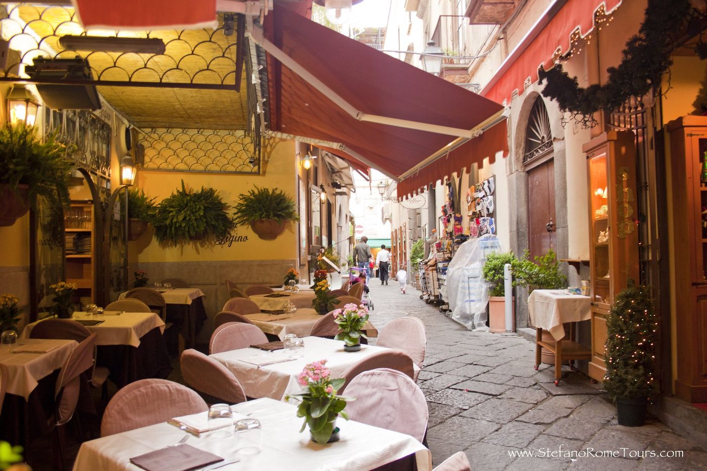 Restaurant tables laid in a narrow lane in Sorrento